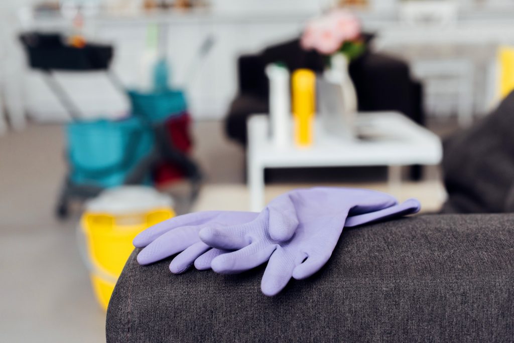 close up of rubber gloves on sofa with blurred background